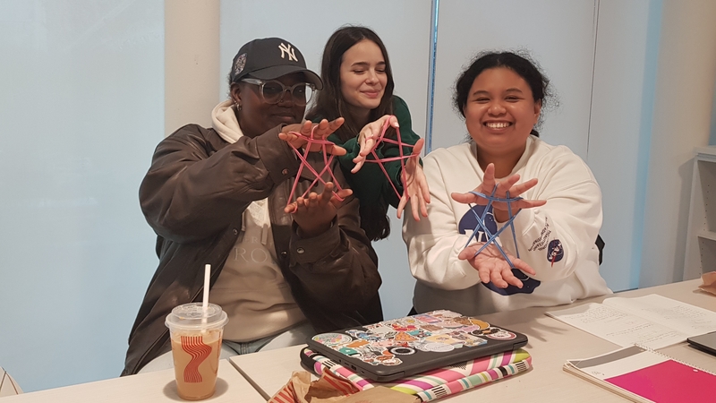 three students displaying a star figure